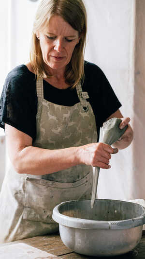 Potter pulling handle of spoon Potter pulling handle of spoon