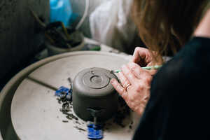 Potter turning on pottery wheel Potter turning on pottery wheel
