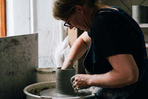 Potter throwing on pottery wheel Potter throwing on pottery wheel